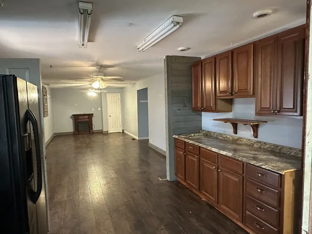 a kitchen with stainless steel appliances granite countertop a refrigerator a stove and a sink