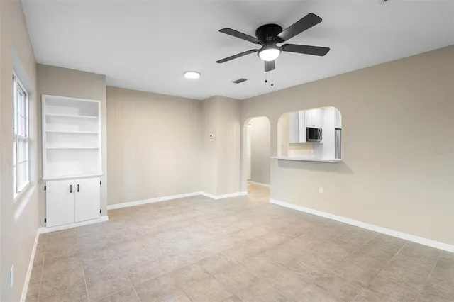 an empty room with closet and windows