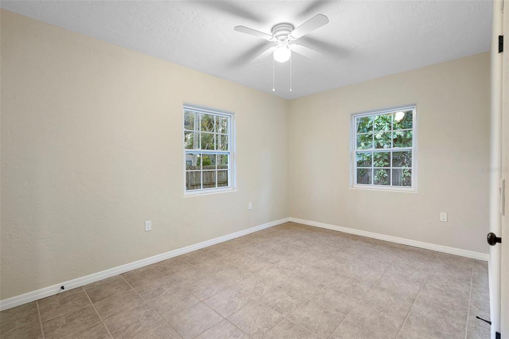 124 Evergreen Avenue Edgewater, FL 32132 - Photo 14 of 36 an empty room with windows and fan