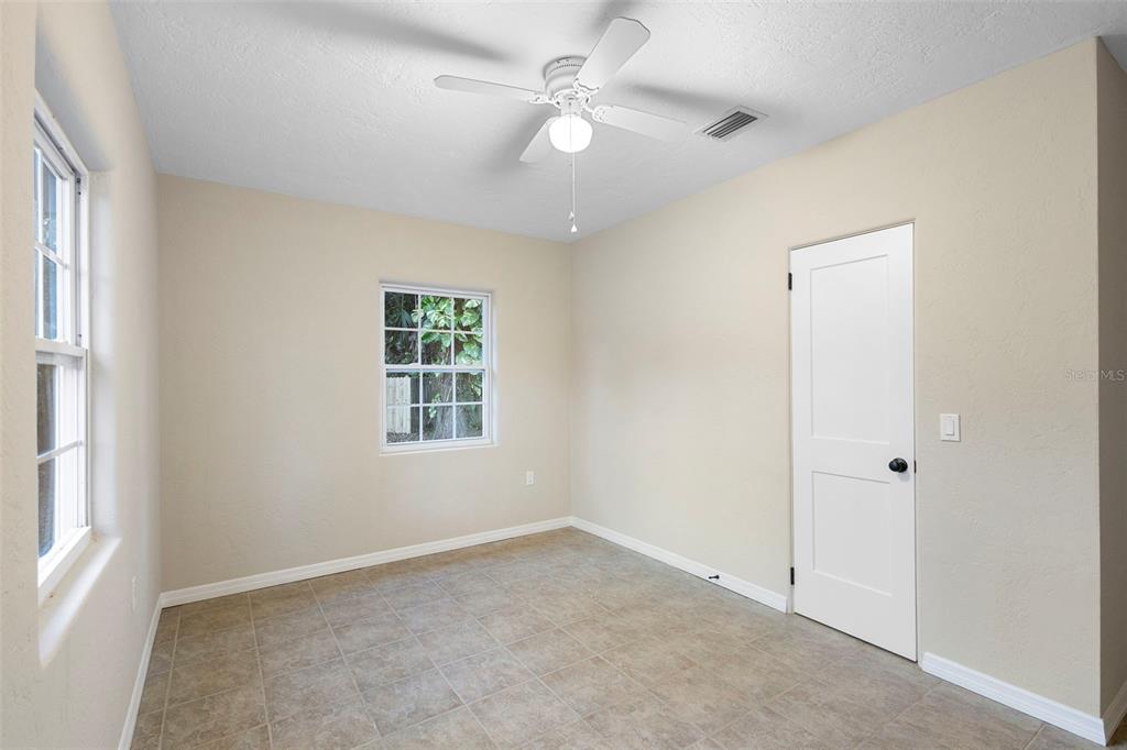 124 Evergreen Avenue Edgewater, FL 32132 - Photo 15 of 36 an empty room with a window and a fan