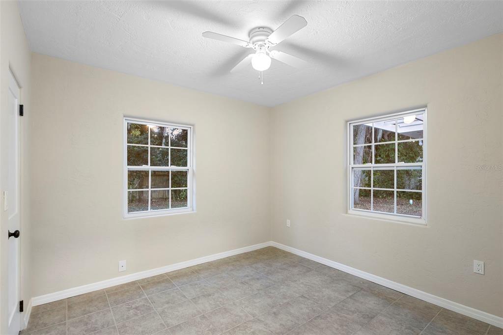 124 Evergreen Avenue Edgewater, FL 32132 - Photo 18 of 36 an empty room with a window and a fan