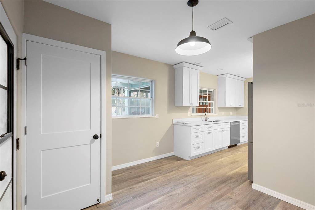 124 Evergreen Avenue Edgewater, FL 32132 - Photo 4 of 36 a kitchen with cabinets wooden floor and a window