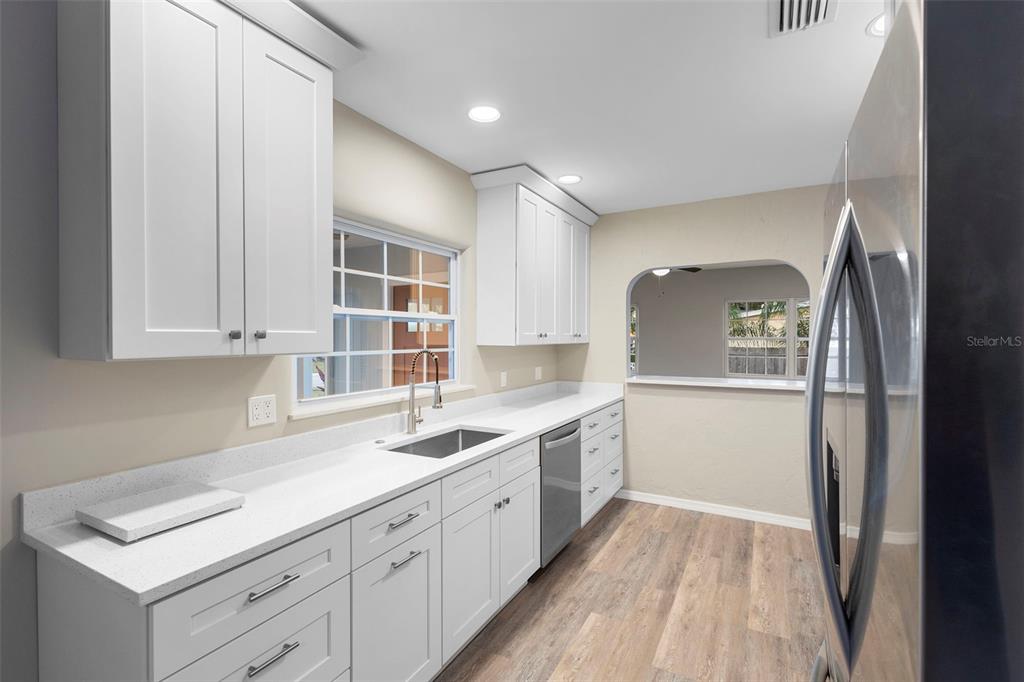 124 Evergreen Avenue Edgewater, FL 32132 - Photo 7 of 36 a kitchen with a sink cabinets stainless steel appliances and a window