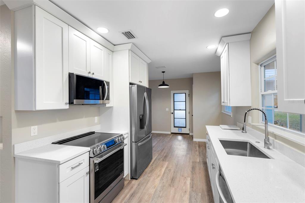 124 Evergreen Avenue Edgewater, FL 32132 - Photo 8 of 36 a kitchen with a sink a stove and cabinets