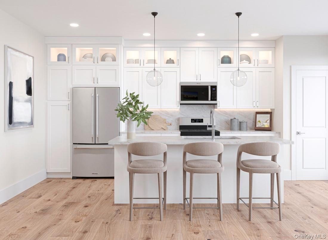 a kitchen with a refrigerator and a stove top oven