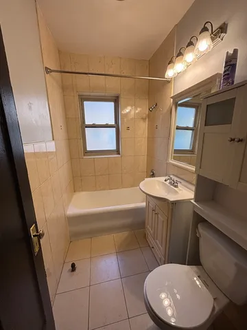 a bathroom with a sink a toilet and bathtub