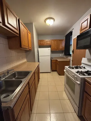 a kitchen with a stove sink and a microwave