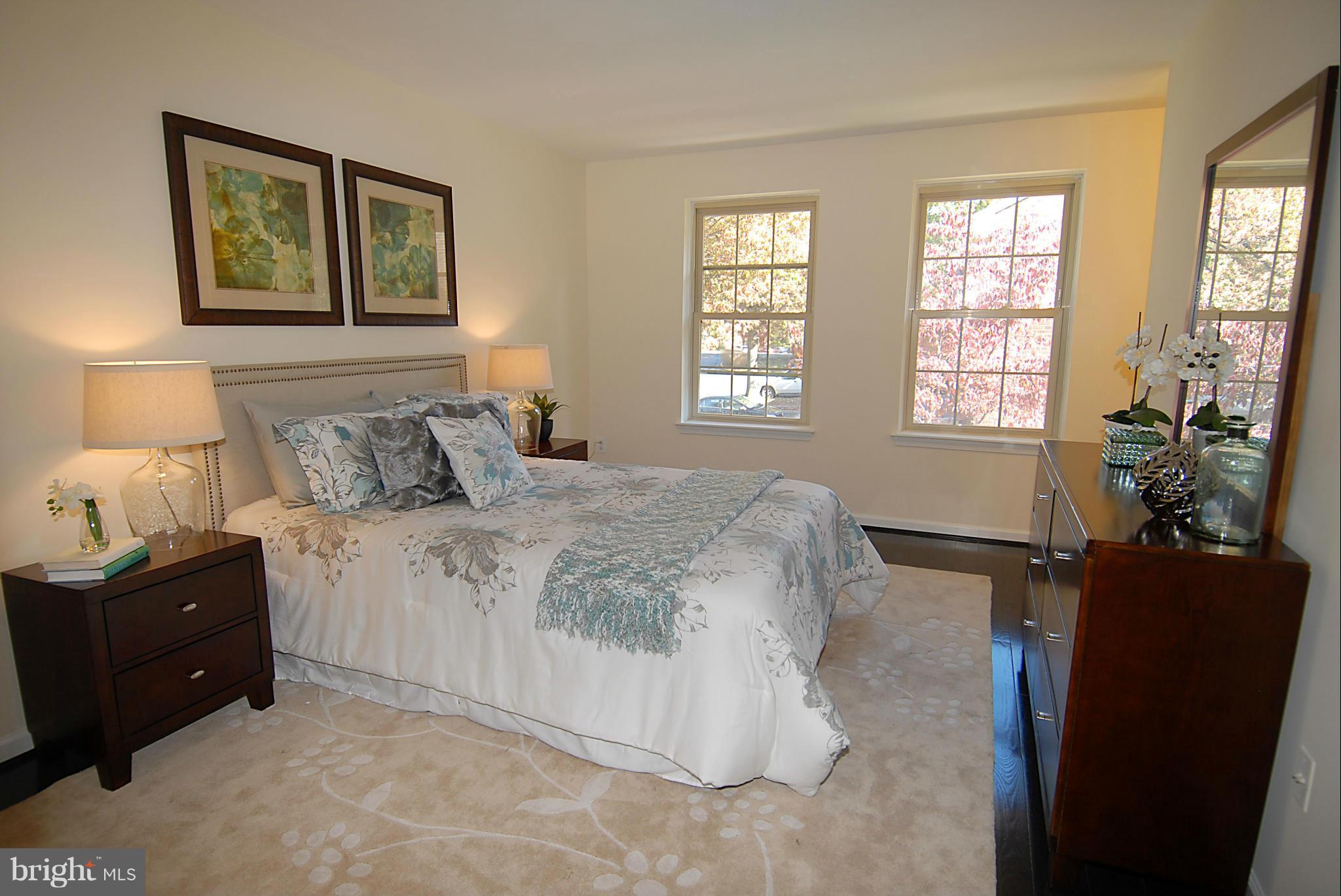 2152 Golf Course Drive Reston, VA 20191 - Photo 16 of 27 a bedroom with a bed and a potted plant