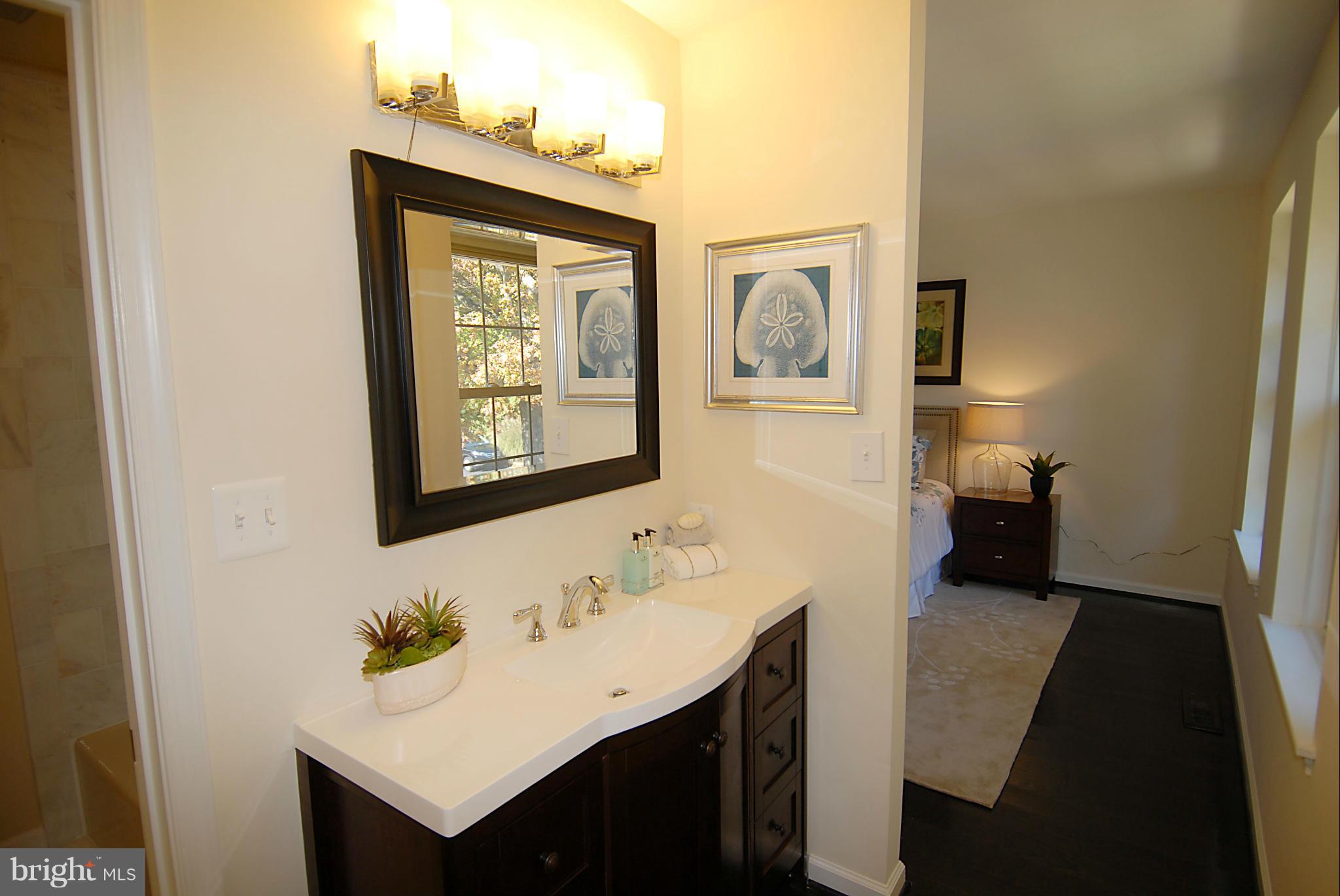 2152 Golf Course Drive Reston, VA 20191 - Photo 17 of 27 a bathroom with a sink vanity and a mirror