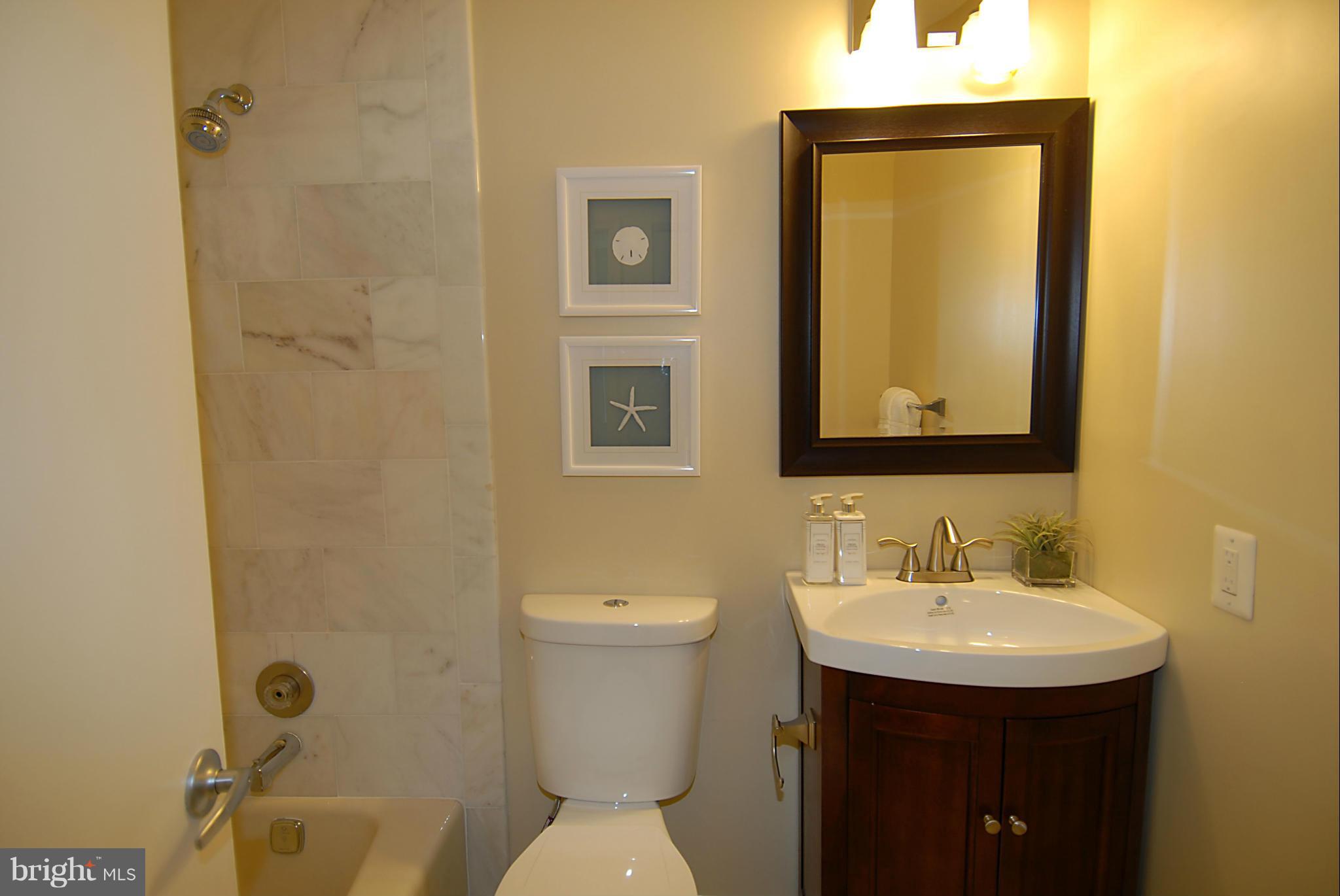 2152 Golf Course Drive Reston, VA 20191 - Photo 18 of 27 a bathroom with a sink toilet and shower