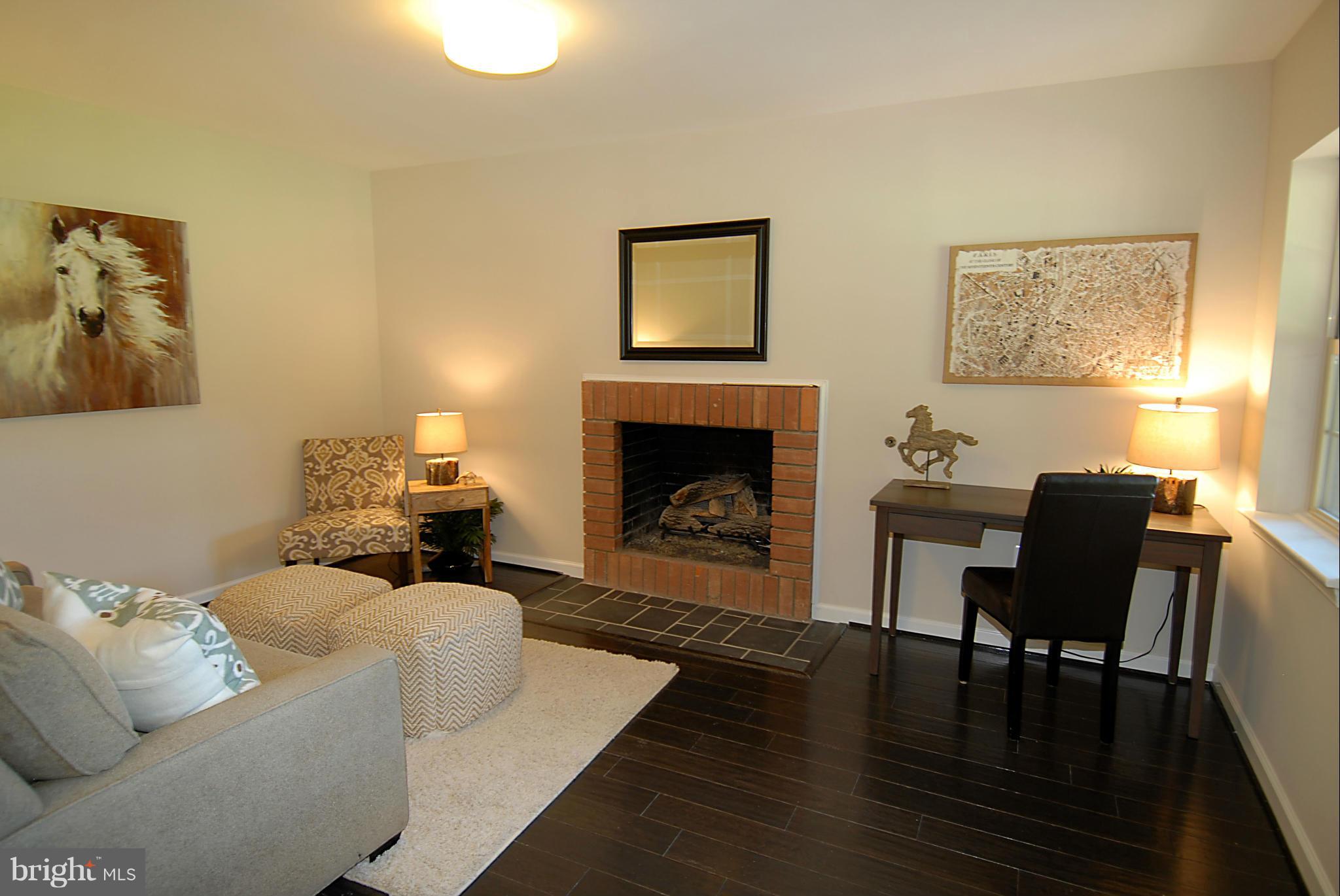 2152 Golf Course Drive Reston, VA 20191 - Photo 20 of 27 a living room with furniture two window and a fireplace