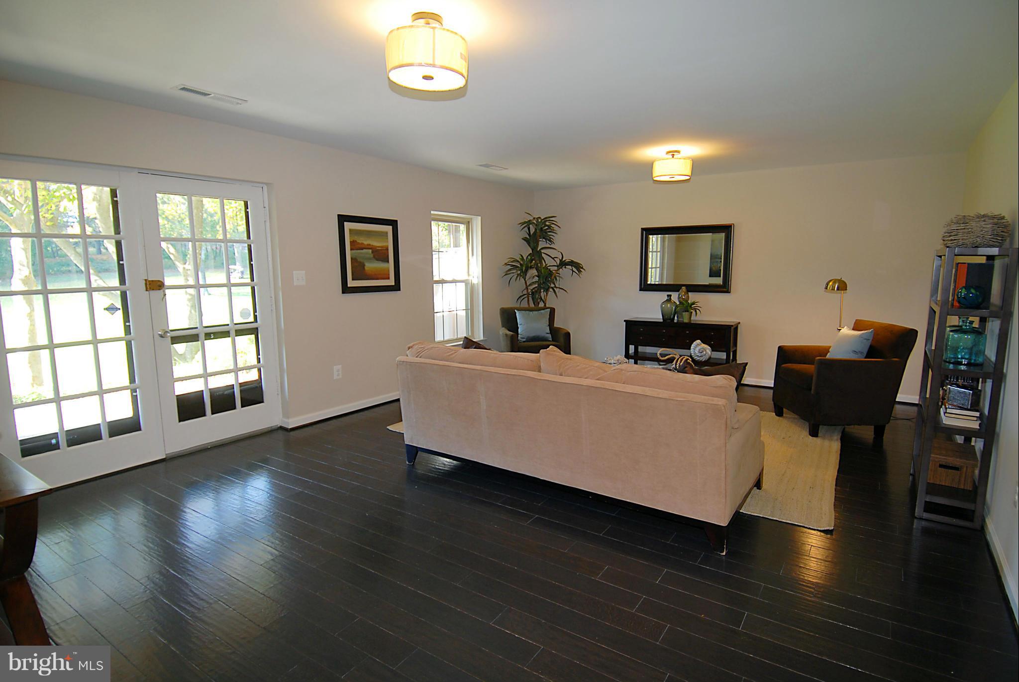 2152 Golf Course Drive Reston, VA 20191 - Photo 24 of 27 a living room with furniture and a wooden floor
