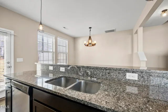 a kitchen with refrigerator and windows