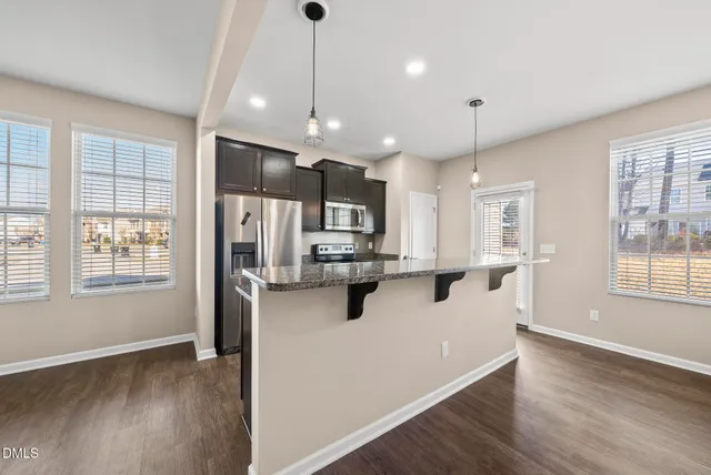 a kitchen with granite countertop a sink and a window