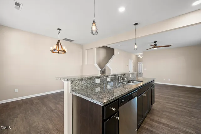 a very nice looking room with wooden floor and a ceiling fan