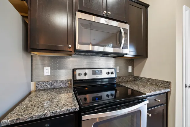 a kitchen with a counter space cabinets and wooden floor