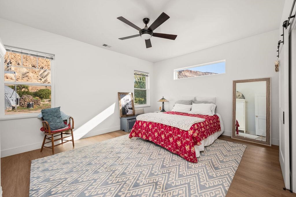 3644 G G 7/10 Road Palisade, CO 81526 - Photo 16 of 42 a bedroom with a bed and a chandelier