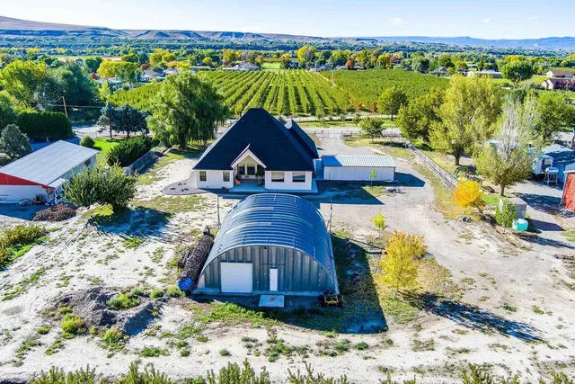 a view of a backyard with plants and lake view