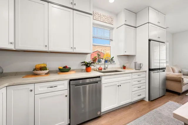a kitchen with cabinets appliances cabinets and a sink