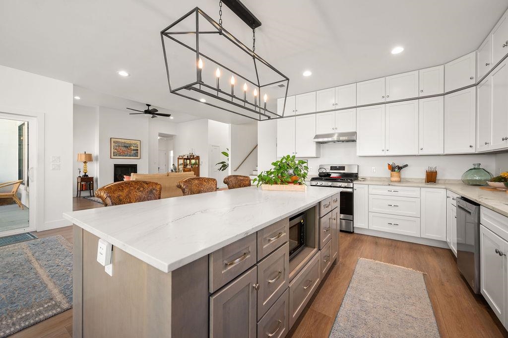 3644 G G 7/10 Road Palisade, CO 81526 - Photo 5 of 42 a large kitchen with kitchen island a large counter top space appliances and cabinets