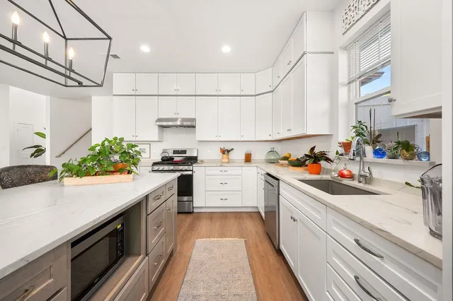 a kitchen with kitchen island granite countertop lots of counter top space and cabinets