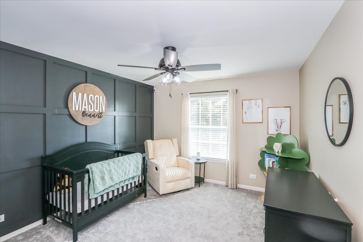 342 Snowdrop Lane Elgin, IL 60124 - Photo 22 of 28 a living room with furniture a clock potted plant and a window