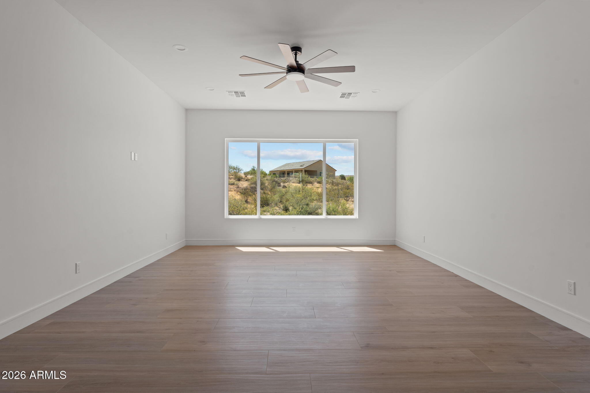 2855 Percheron Road Wickenburg, AZ 85390 - Photo 33 of 58 an empty room with fan and windows
