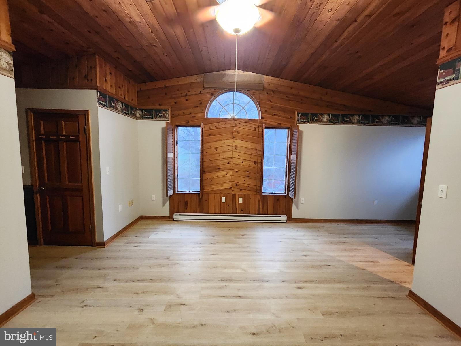 20307 Pond Circle Road Midlothian, MD 21543 - Photo 10 of 29 a view of an empty room with wooden floor and a window