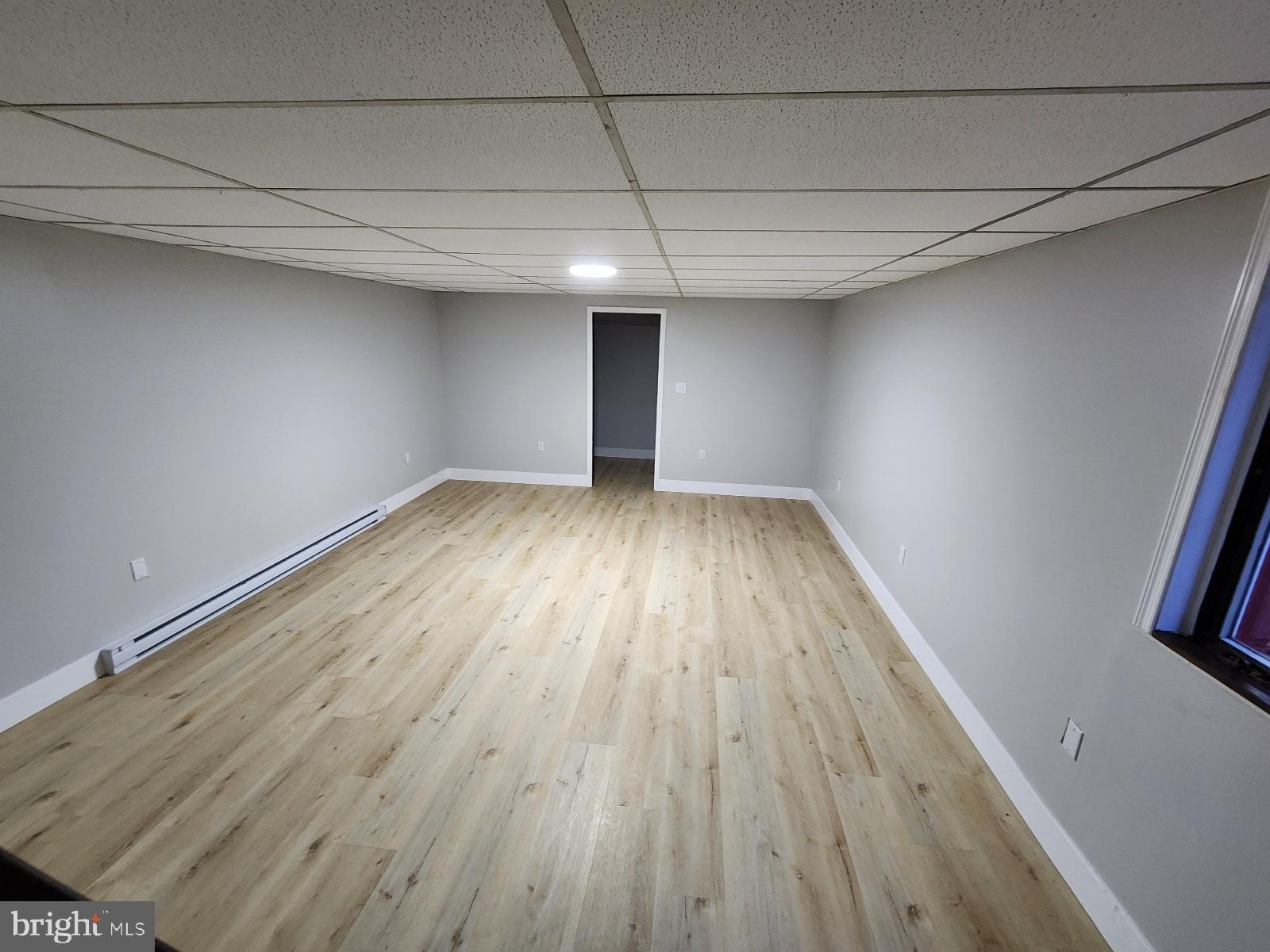 20307 Pond Circle Road Midlothian, MD 21543 - Photo 15 of 29 an empty room with wooden floor and windows