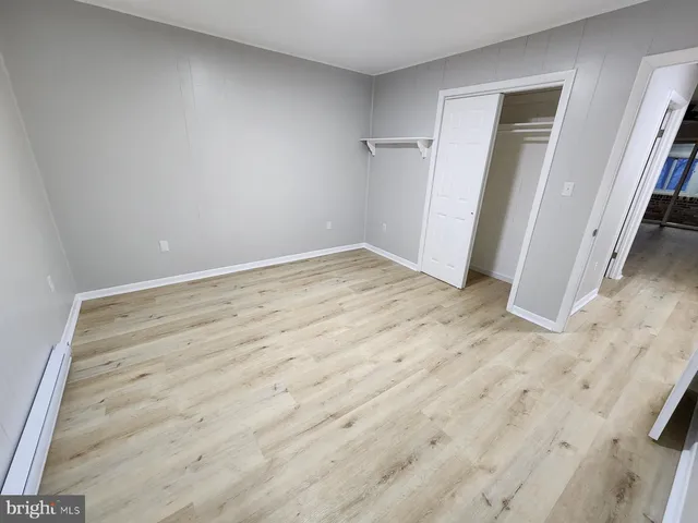 a view of a room with a wooden floor and a window