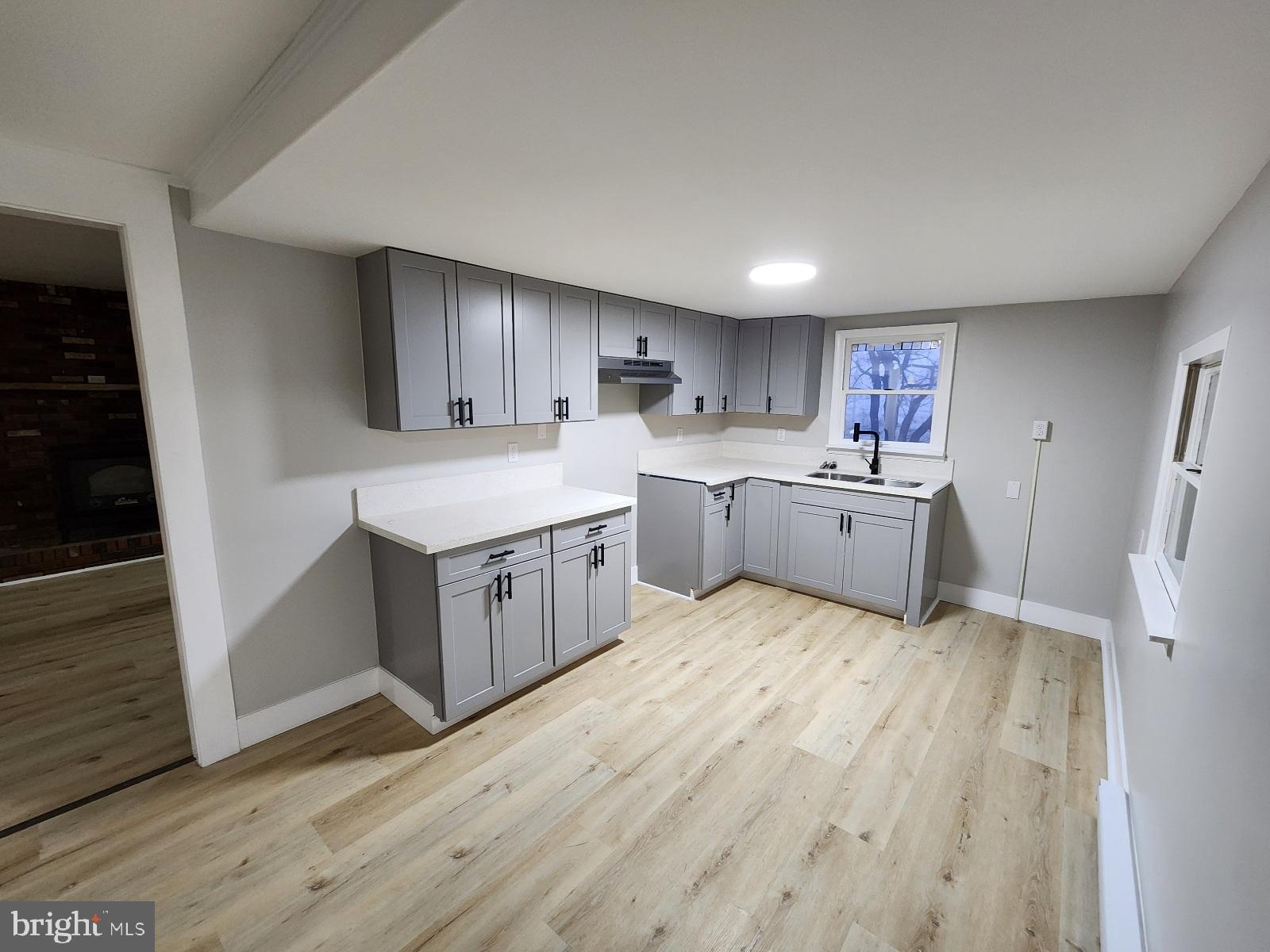 20307 Pond Circle Road Midlothian, MD 21543 - Photo 6 of 29 a large white kitchen with a sink dishwasher a refrigerator and a stove with wooden floor