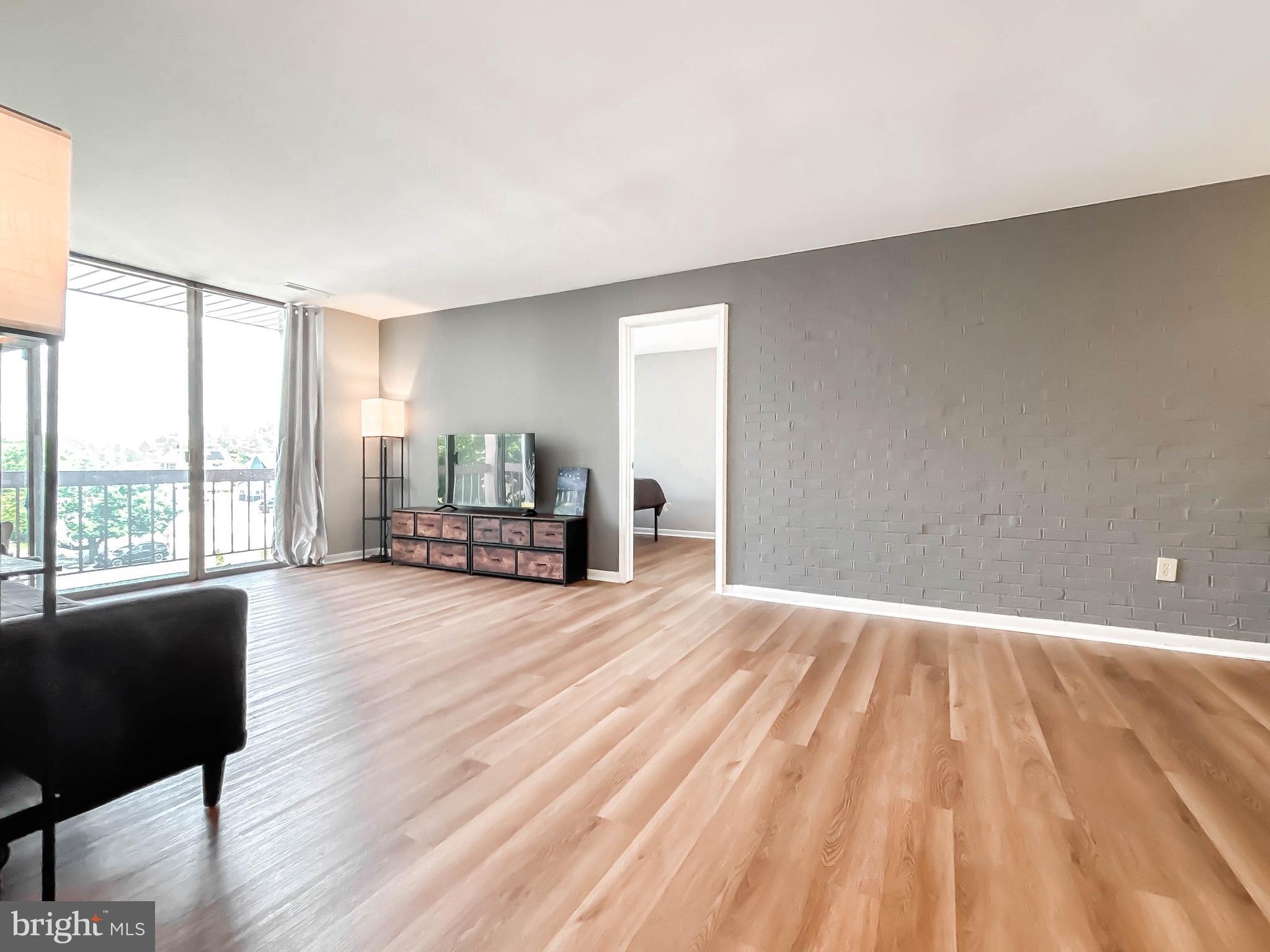 130 Slade Avenue, Unit 414 Baltimore, MD 21208 - Photo 10 of 48 a view of empty room with wooden floor and fan