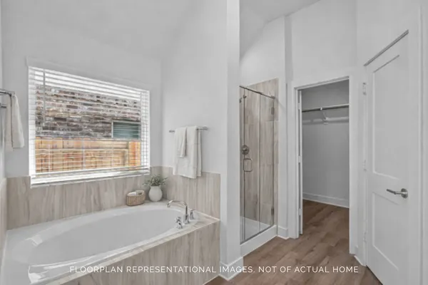 a bedroom with a large bed couch and a window