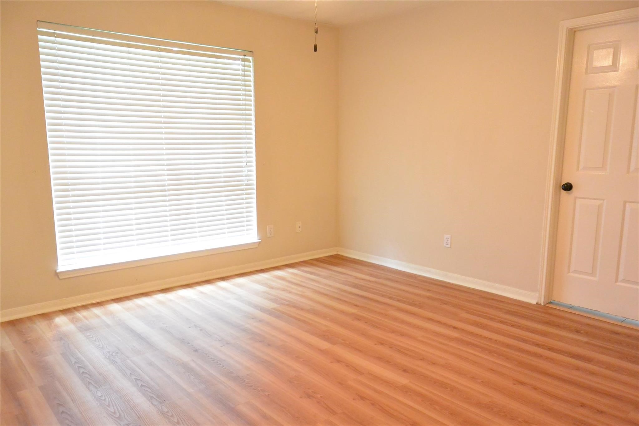 23615 Tree House Lane Spring, TX 77373 - Photo 11 of 12 a view of an empty room with wooden floor and a window