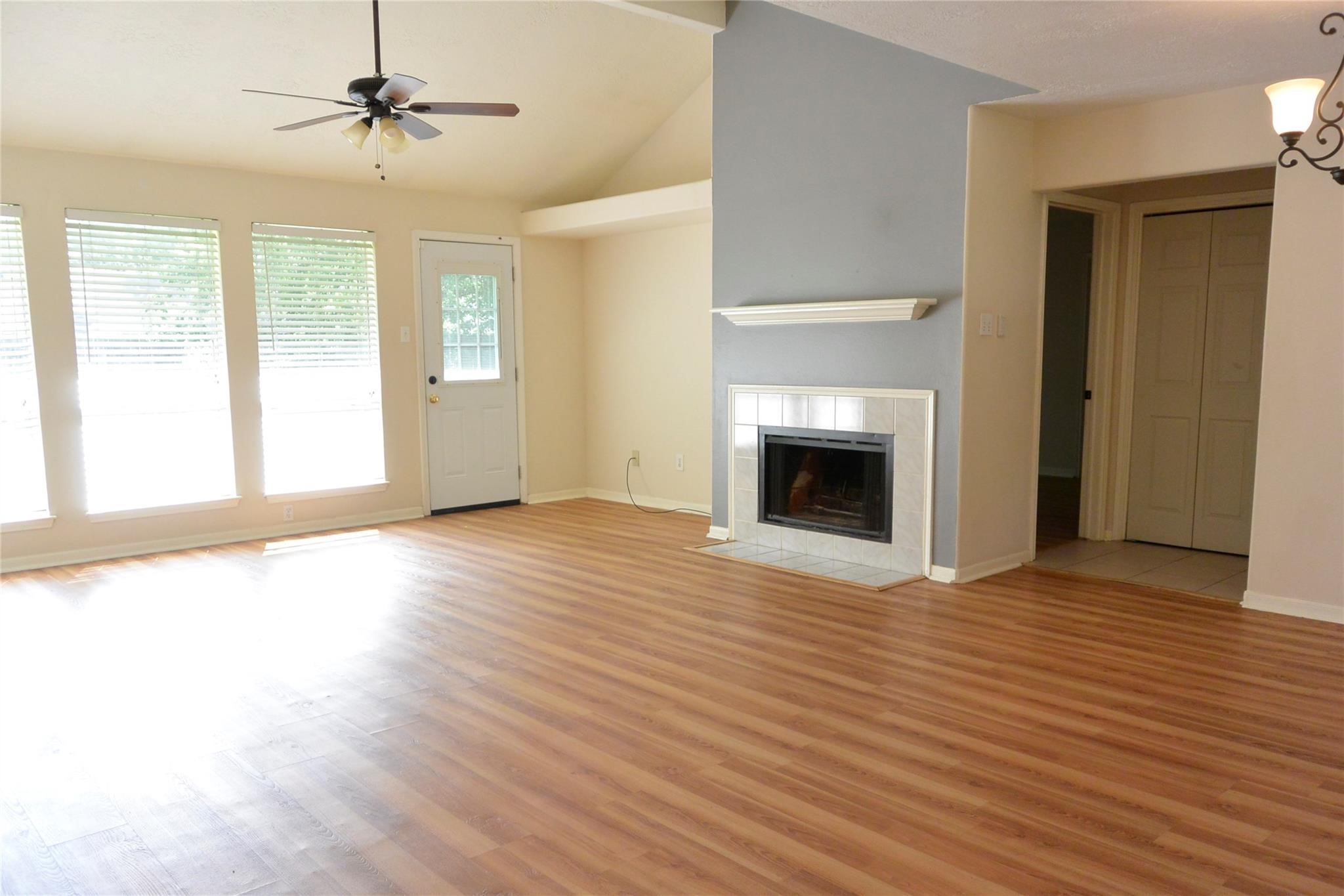 23615 Tree House Lane Spring, TX 77373 - Photo 4 of 12 a view of an empty room with wooden floor fireplace and a window