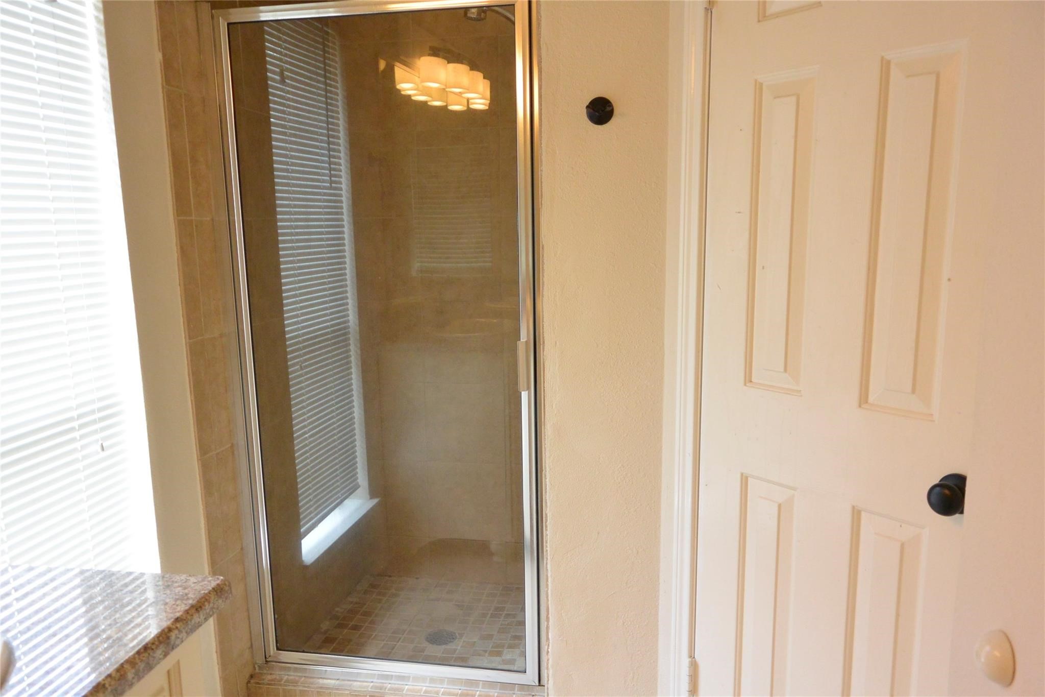 23615 Tree House Lane Spring, TX 77373 - Photo 5 of 12 a view of a bathroom from a hallway