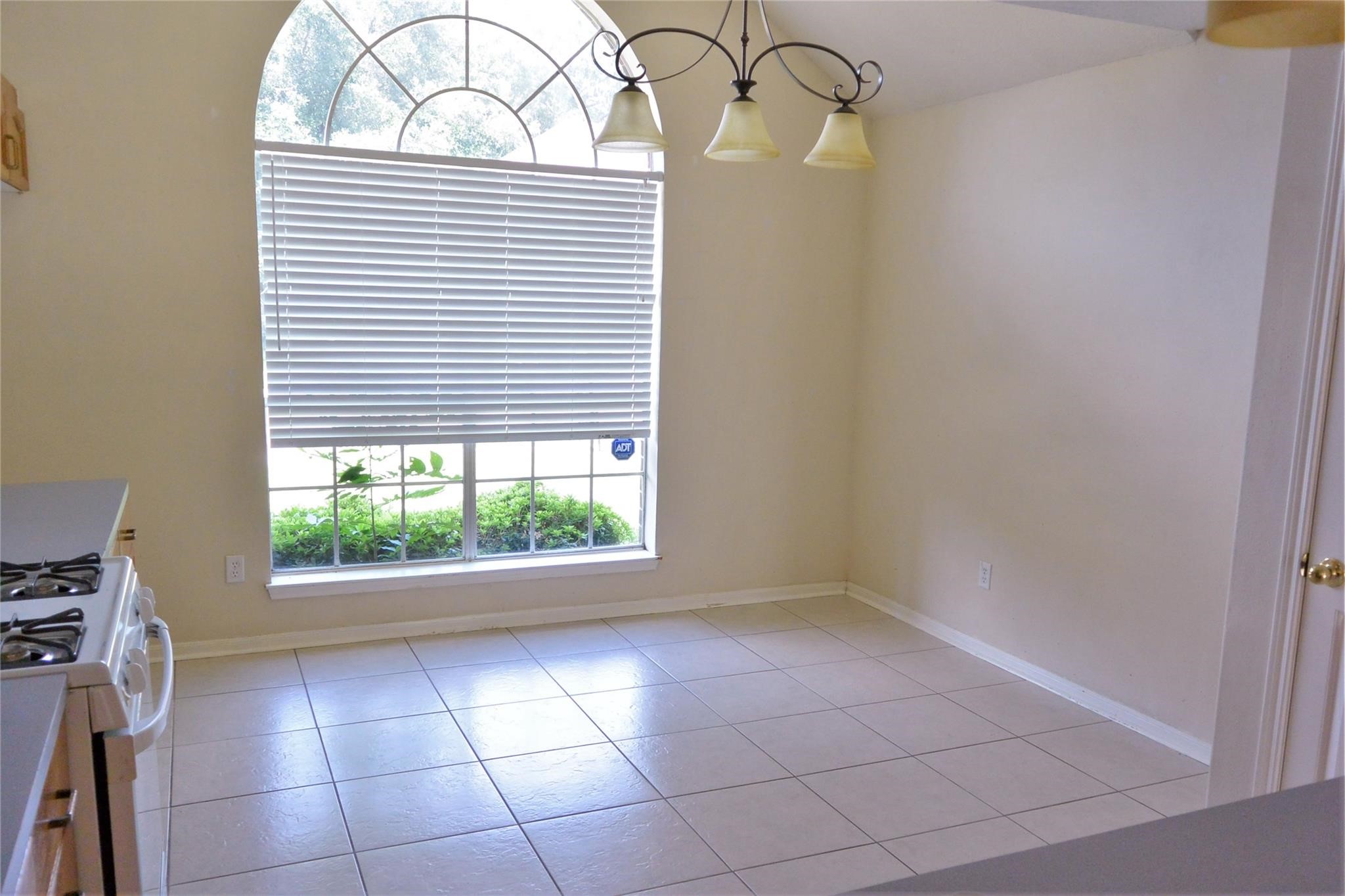 23615 Tree House Lane Spring, TX 77373 - Photo 8 of 12 a view of an empty room with a window and a fireplace