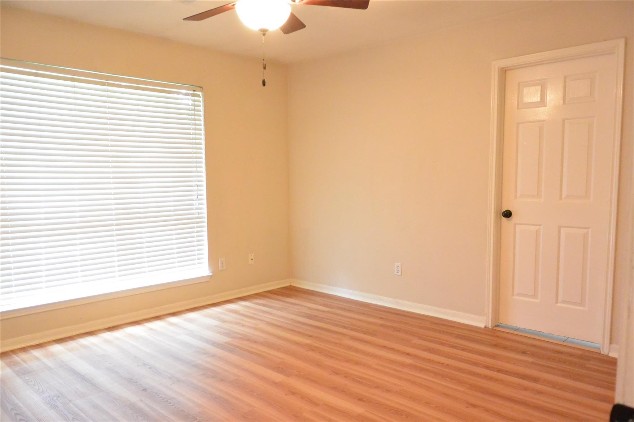 23615 Tree House Lane Spring, TX 77373 - Photo 10 of 12 a view of an empty room with wooden floor and a window