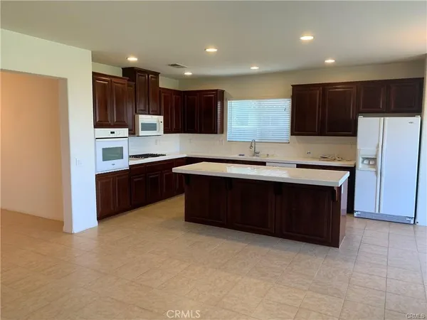 a kitchen with a sink a stove a refrigerator and a oven
