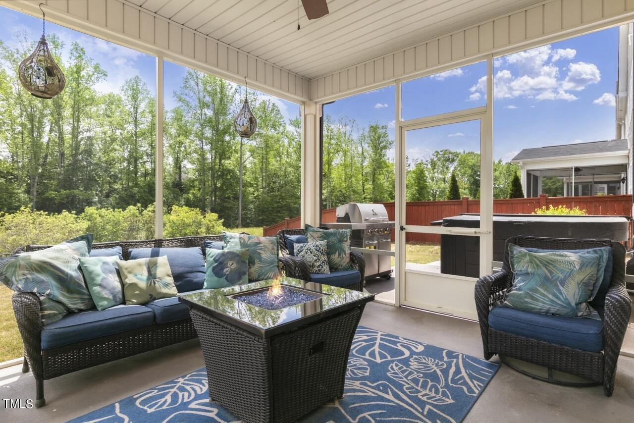 3356 Table Mountain Pine Drive Raleigh, NC 27616 - Photo 16 of 41 a living room with patio furniture and a floor to ceiling window