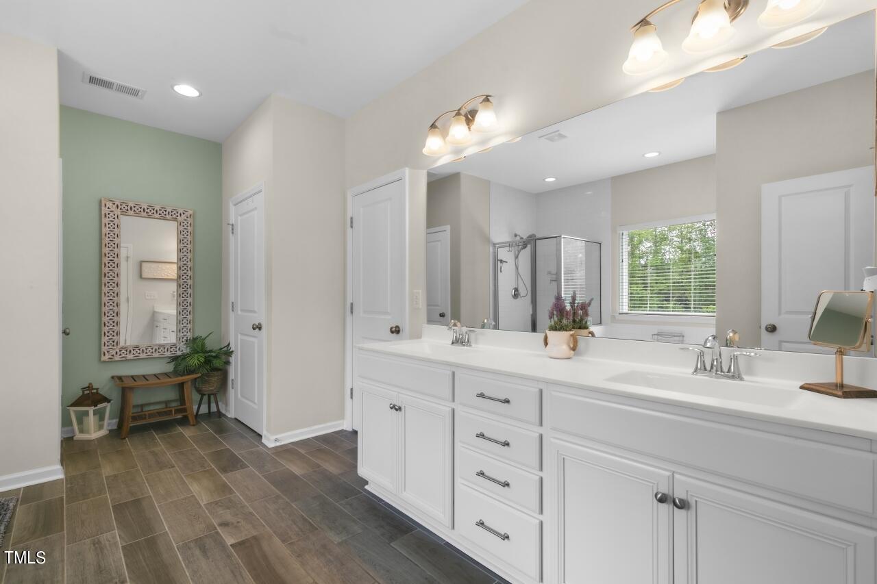 3356 Table Mountain Pine Drive Raleigh, NC 27616 - Photo 21 of 41 a bathroom with a double vanity sink a mirror and a bathtub