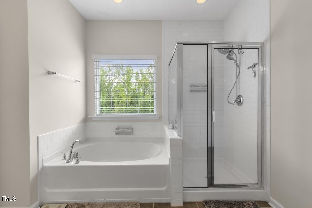 3356 Table Mountain Pine Drive Raleigh, NC 27616 - Photo 22 of 41 a bathroom with a bathtub and a shower