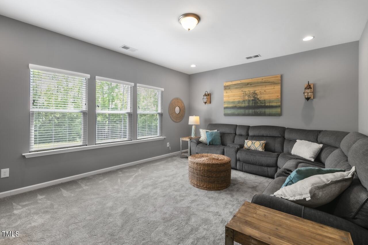 3356 Table Mountain Pine Drive Raleigh, NC 27616 - Photo 23 of 41 a living room with furniture and a flat screen tv