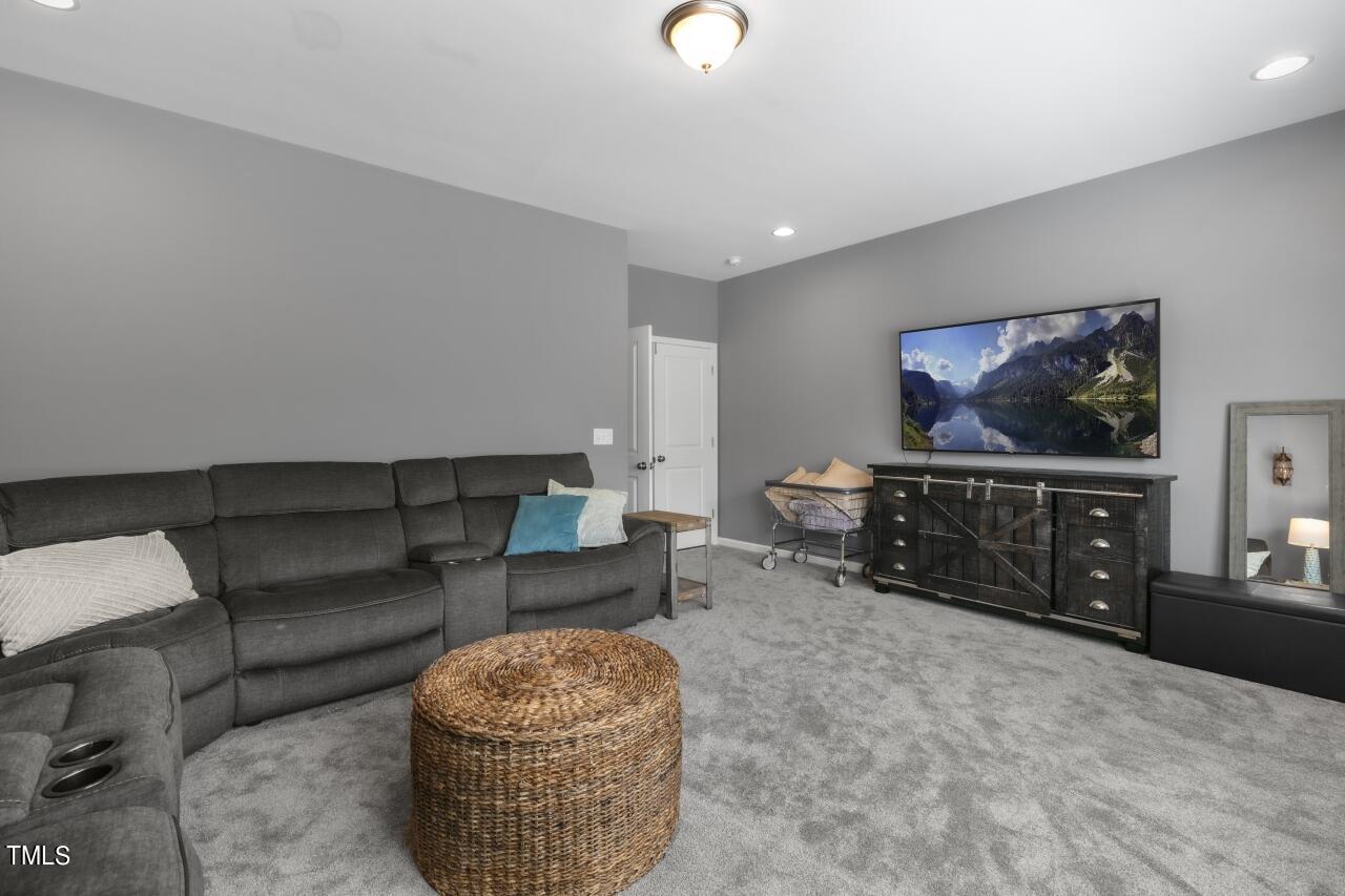 3356 Table Mountain Pine Drive Raleigh, NC 27616 - Photo 24 of 41 a living room with furniture and a flat screen tv