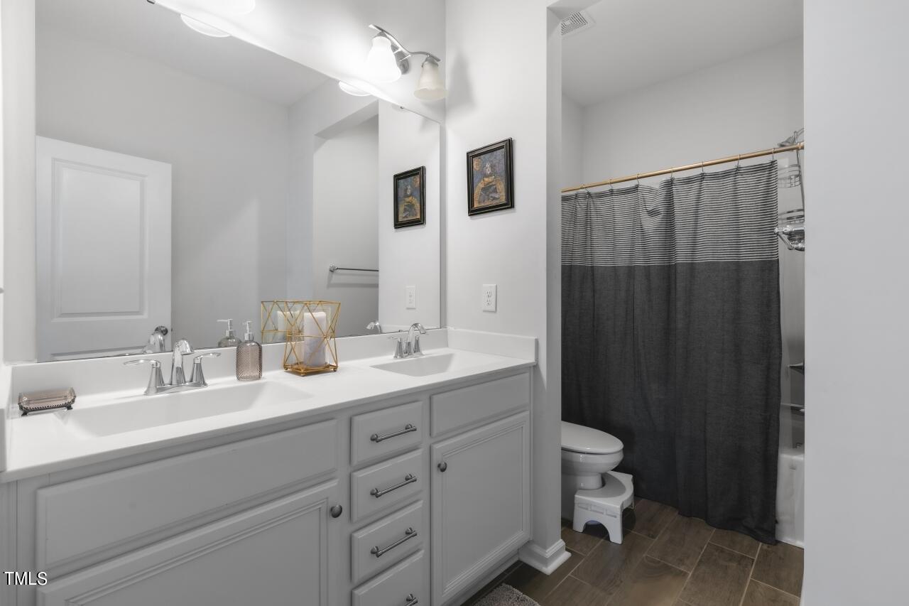 3356 Table Mountain Pine Drive Raleigh, NC 27616 - Photo 25 of 41 a bathroom with a double vanity sink toilet and shower