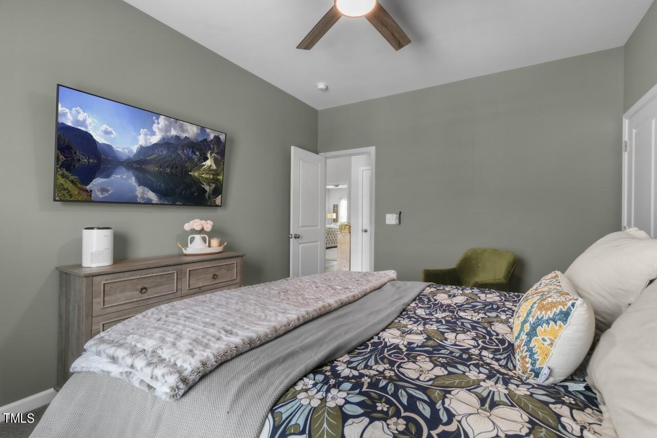 3356 Table Mountain Pine Drive Raleigh, NC 27616 - Photo 29 of 41 a bedroom with a bed and a flat screen tv
