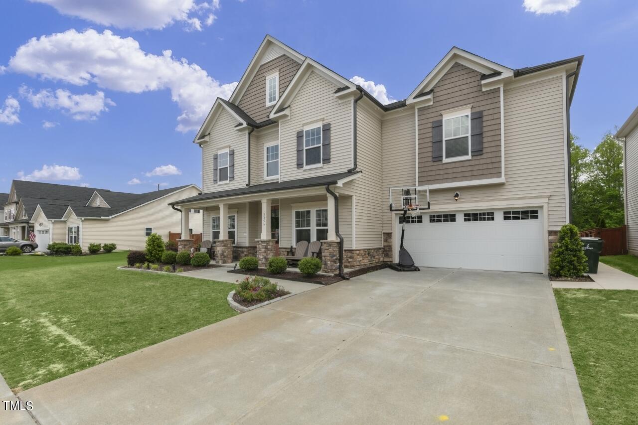 3356 Table Mountain Pine Drive Raleigh, NC 27616 - Photo 33 of 41 a view of a white house with a big yard and large trees