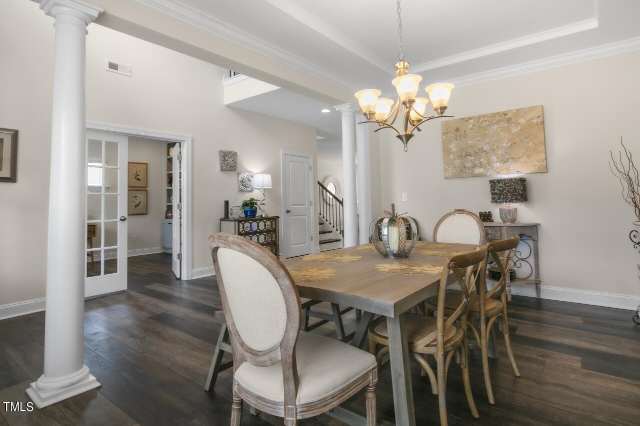 3356 Table Mountain Pine Drive Raleigh, NC 27616 - Photo 6 of 41 a dining room with furniture a chandelier and wooden floor