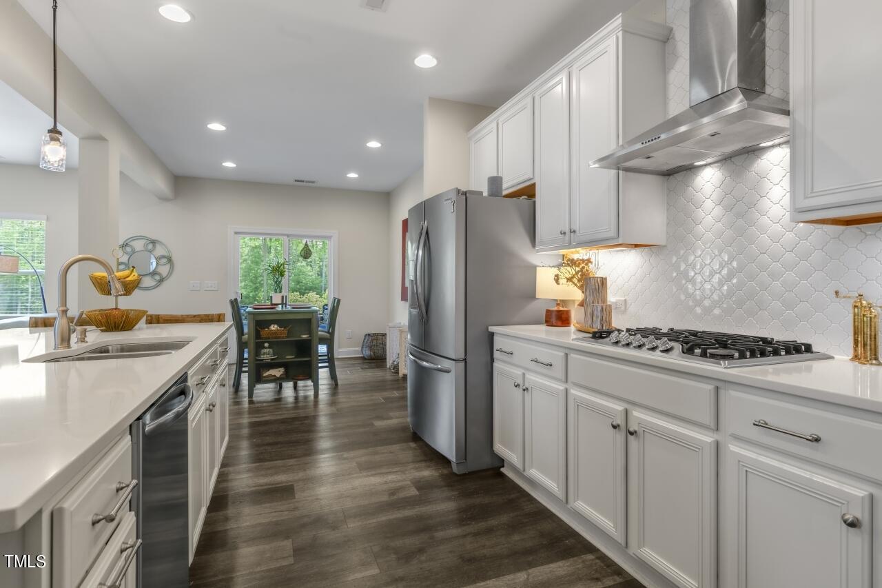 3356 Table Mountain Pine Drive Raleigh, NC 27616 - Photo 8 of 41 a kitchen with stainless steel appliances granite countertop a sink stove and refrigerator