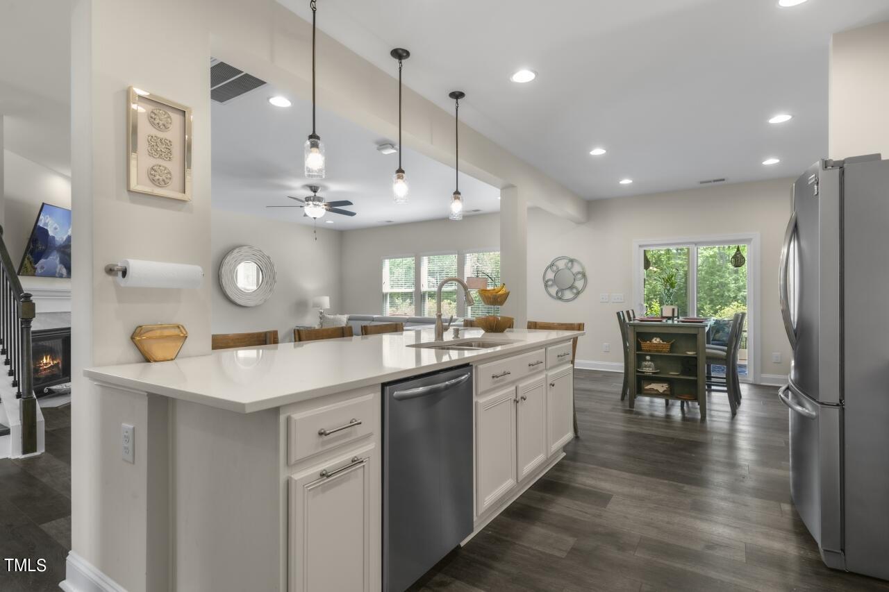 3356 Table Mountain Pine Drive Raleigh, NC 27616 - Photo 9 of 41 a kitchen with kitchen island granite countertop a sink a counter space appliances and cabinets